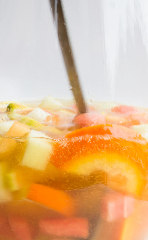 Stirring Melon Sangria in a Pitcher
