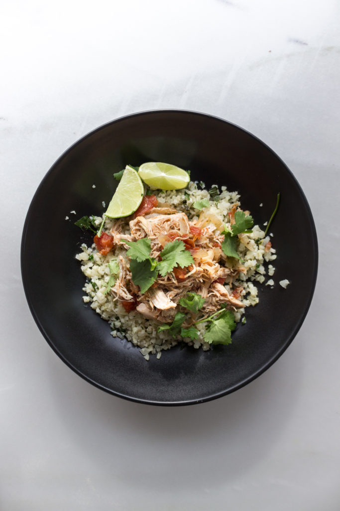 Mexican Chicken with Cilantro Lime Cauliflower Rice in a Black Bowl